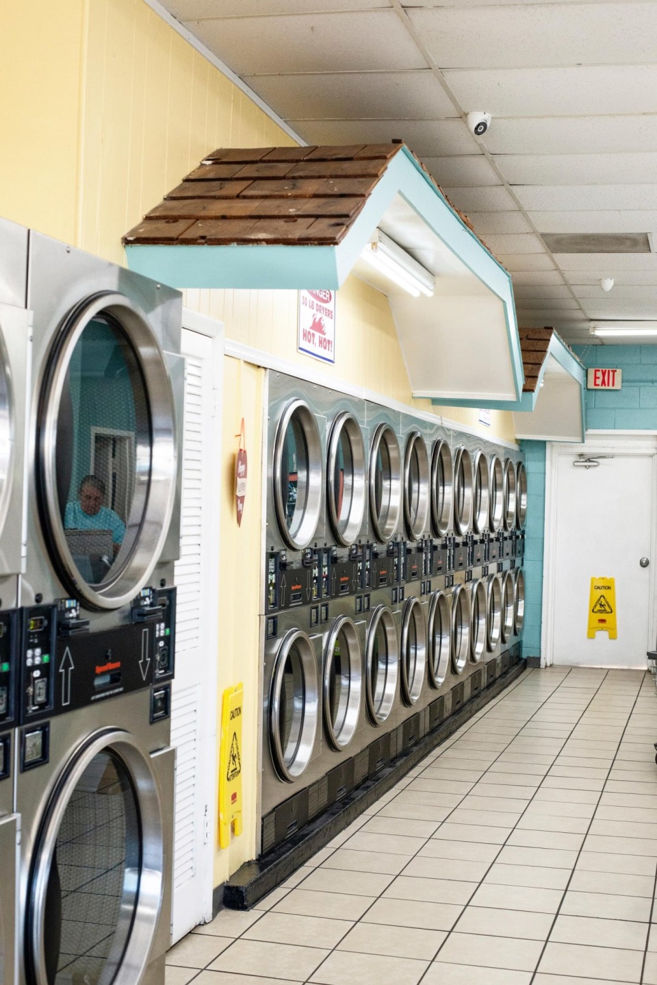 Stacked dryers beside a row of washers