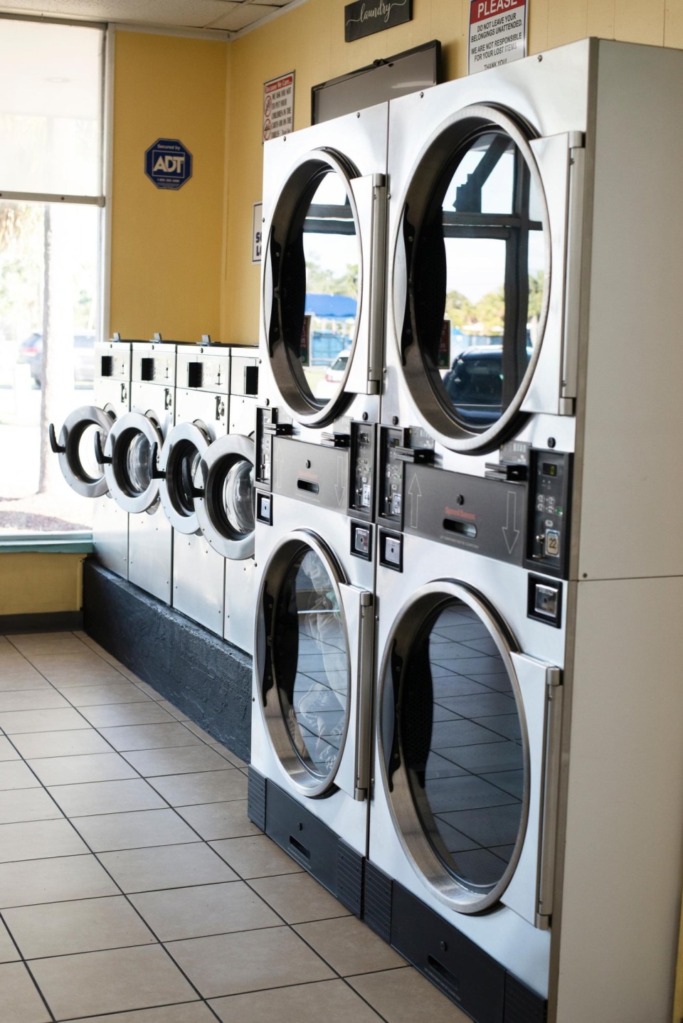Stacked dryers by the front windows
