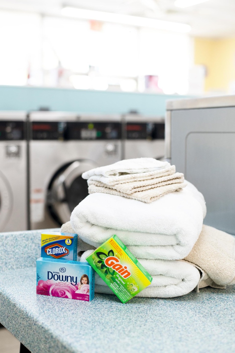 Folded towels and laundry supplies on the folding counter