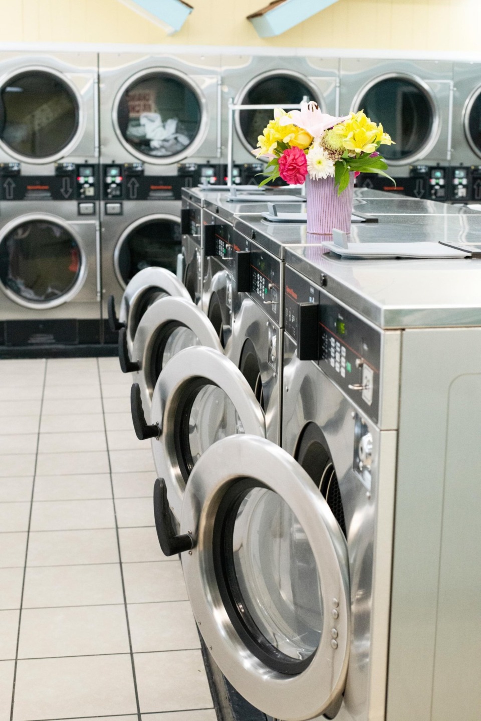 Row of washers with flowers on the folding counter