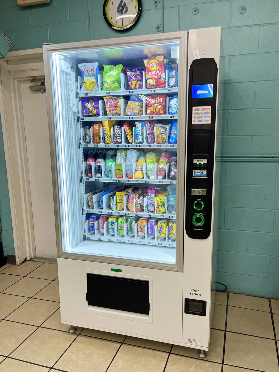 Vending machine stocked with laundry supplies and snacks