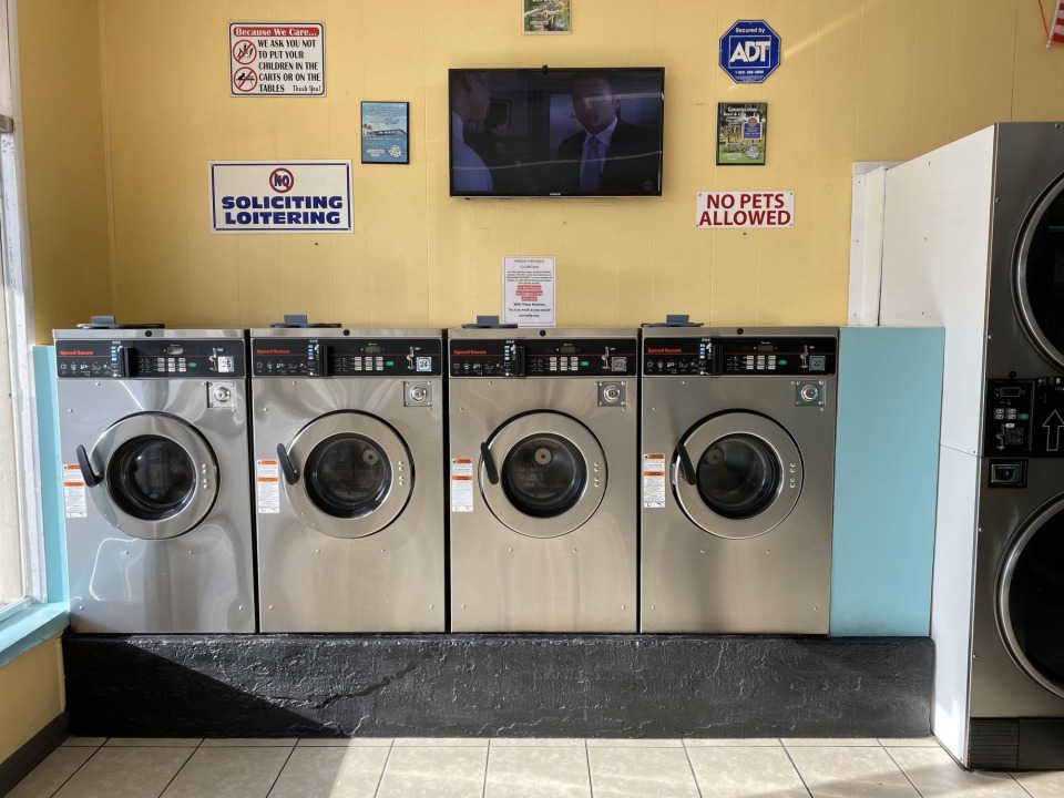 Row of stacked dryers and folding counter